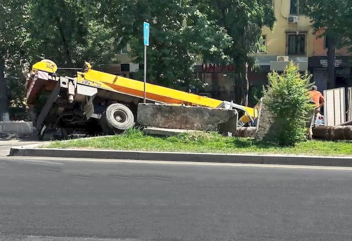 Truck crane falls into a trench dug for laying pipes